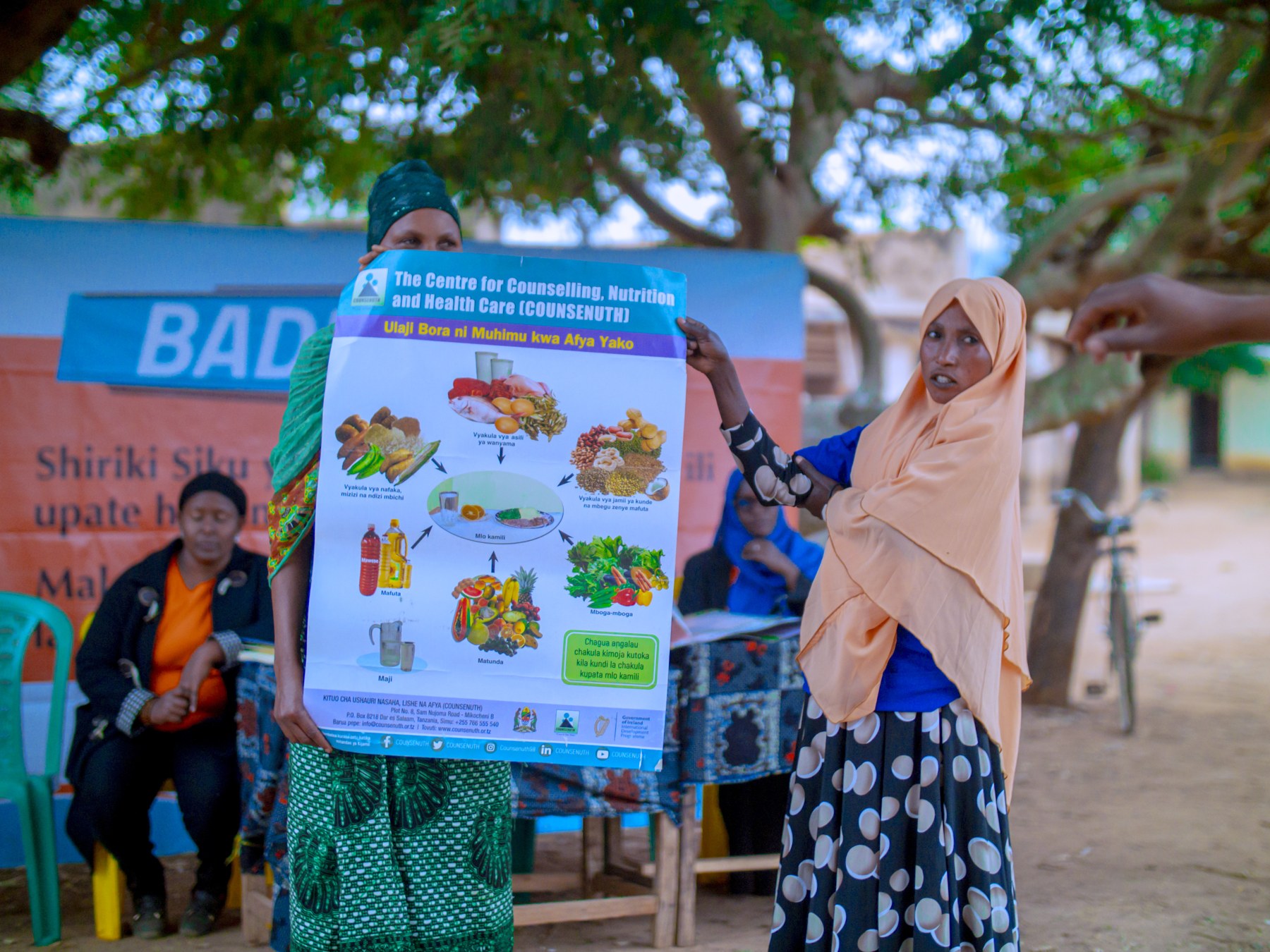 A community educator presenting a nutrition poster